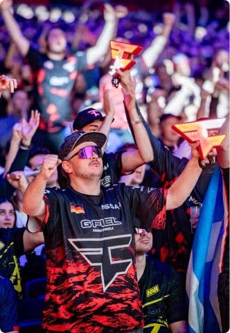 Esports fans cheering in a packed arena